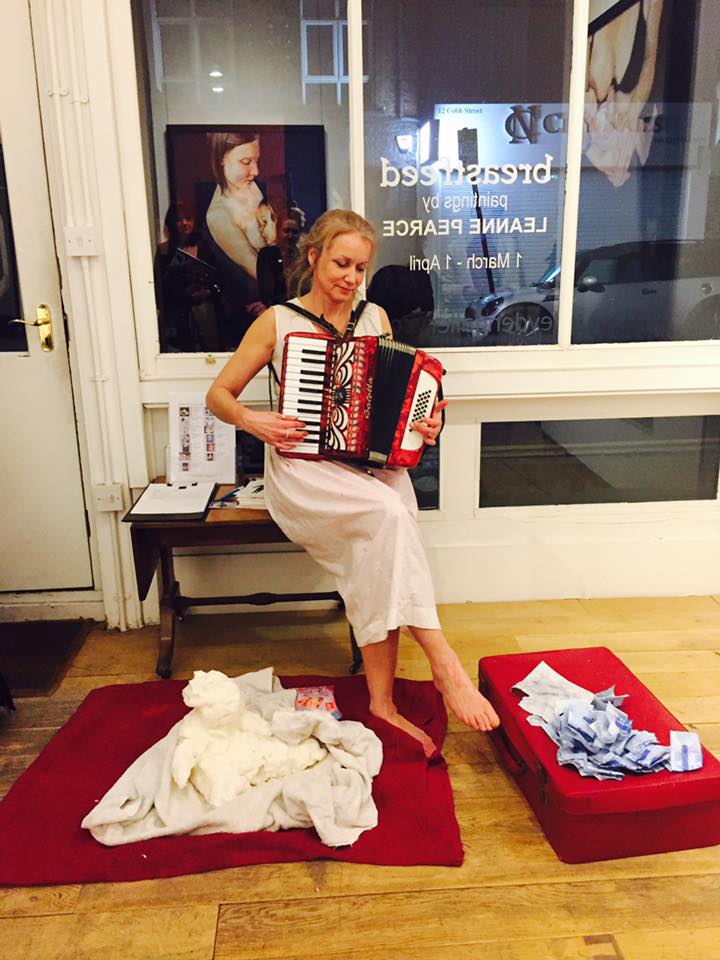 playing an accordion as part of a performance called double burden